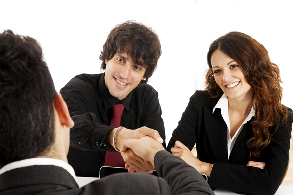 Young married couple at desk in a business meeting